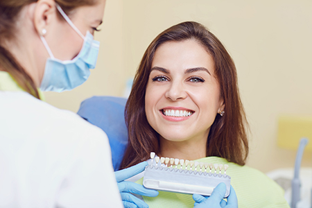 A woman receiving dental care from a professional in a dental office setting.